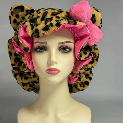 Leopard print bonnet with pink interior on a mannequin head against a gray background